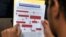 FILE - A legal immigrant reads a guide of the conditions needed to apply for the so-called 'DREAMers' Obama program, formally known as Deferred Action for Childhood Arrivals (DACA) at the Coalition for Humane Immigrant Rights, CHIRLA offices in Los Angeles, Aug. 15, 2012.
