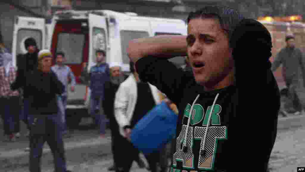 A Syrian man reacts after an air strike by pro-government forces on the city of Aleppo on November 28, 2013.