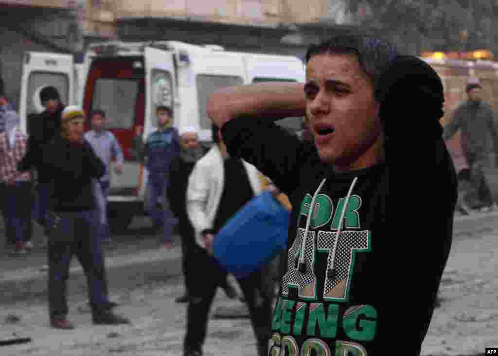 A Syrian man reacts after an air strike by government forces on the city of Aleppo, Syria.