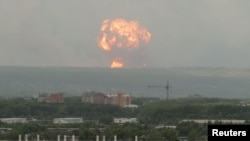 Flame and smoke rise from the site of blasts at an ammunition depot near the town of Achinsk in Krasnoyarsk region, Russia.