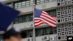 FILE - A South Korean police officer stands guard near the U.S. embassy in Seoul, South Korea, June 27, 2019. 