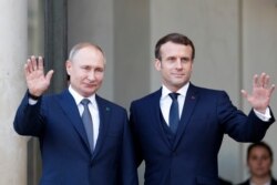 FILE - French President Emmanuel Macron, right, and Russian President Vladimir Putin at the Elysee Palace in Paris, Dec. 9, 2019.