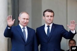 FILE - French President Emmanuel Macron, right, and Russian President Vladimir Putin at the Elysee Palace in Paris, Dec. 9, 2019.