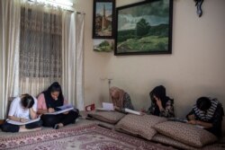 Afghan girls practice painting under the guidance of an Afghan artist Akbar Farhad inside his rented accommodation in New Delhi, India on Aug. 17, 2021. Farhad has been living in New Delhi since 2018.