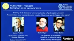 A screen displays the portraits of the laureates of the 2019 Nobel Prize in Physics (L-R) James Peebles, Michel Mayor and Didier Queloz, during a news conference at the Royal Swedish Academy of Sciences in Stockholm, Sweden, October 8, 2019. 