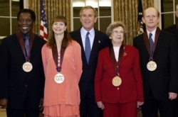 FILE - In this photo taken Nov. 12, 2003, President George Bush, center, stands in the Oval Office with recipients of the National Medal of Arts. From left: musician Buddy Guy, dancer Suzanne Farrell, author Beverly Cleary and actor Ron Howard.