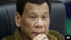 FILE - Philippine President Rodrigo Duterte listens during a command conference on Typhoon Mangkhut, locally named Typhoon Ompong, at the National Disaster Risk Reduction and Management Council operations center in metropolitan Manila, Philippines, Sept. 13, 2018.