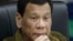 FILE - Philippine President Rodrigo Duterte listens during a command conference on Typhoon Mangkhut, locally named Typhoon Ompong, at the National Disaster Risk Reduction and Management Council operations center in metropolitan Manila, Philippines, Sept. 13, 2018.
