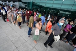 Residents wait on line to receive the COVID-19 vaccine at the Central Vaccination Center in Bangkok, Thailand, July 22, 2021.