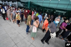 Residents wait on line to receive the COVID-19 vaccine at the Central Vaccination Center in Bangkok, Thailand, July 22, 2021.