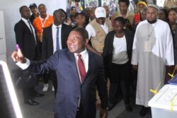 Mozambican President Felipe Nyusi is seen at a polling station in Maputo after he cast his vote, Oct. 15, 2019 in the country's presidential, parliamentary and provincial elections.