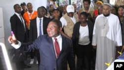 Mozambican President Felipe Nyusi is seen at a polling station in Maputo after he cast his vote, Oct. 15, 2019, in the country's presidential, parliamentary and provincial elections.
