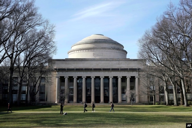 FILE - Students walk past the "Great Dome" atop Building 10 on the Massachusetts Institute of Technology campus in Cambridge, Mass, April 3, 2017. (AP Photo/Charles Krupa, File)