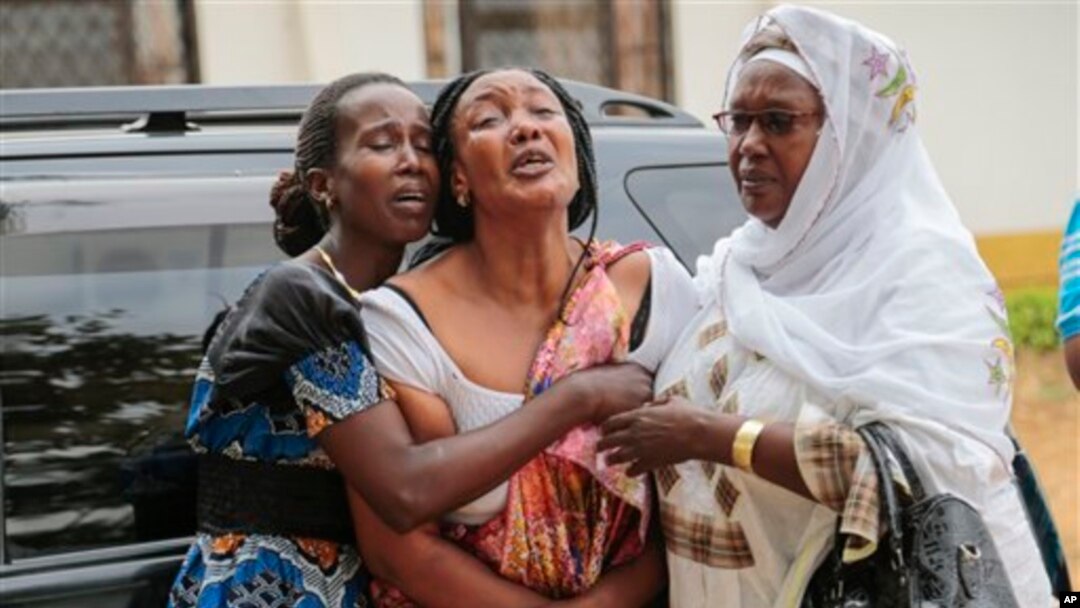 Relatives and friends grieve during the funeral of Patrick Ndikumana, Friday, July 3, 2015, in Bujumbura, Burundi. According to relatives Ndikumana was killed in the police attack in Jabe neighborhood last week. A U.N. observer mission concluded Thursday