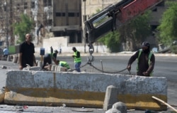 Iraqi municipal workers clean up Tayaran Square in central Baghdad on Oct. 5, 2019 after a curfew was lifted following a day of violent protests.