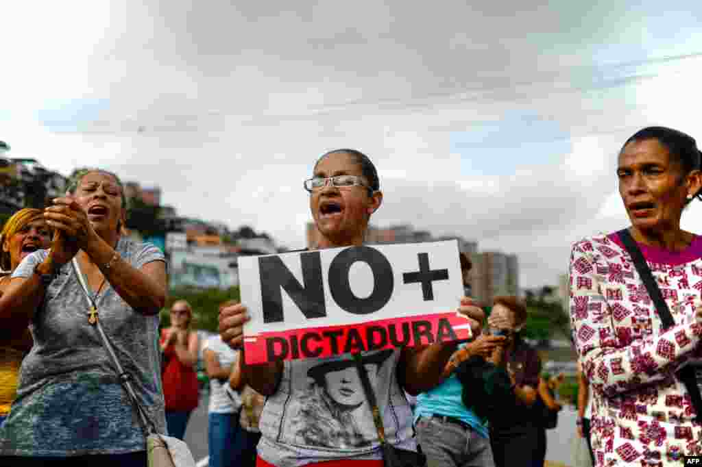 Venezuelan opposition activists march along a street of Caracas, March 31, 2017 chanting slogans against the government of President Nicolas Maduro. 