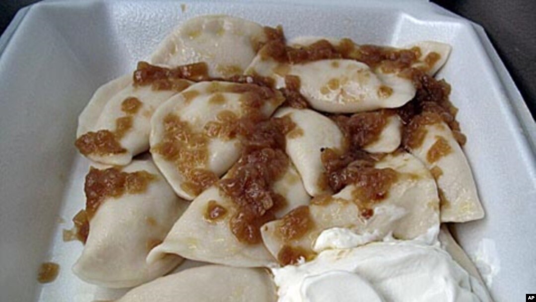 A to-go serving from St. John's Baptist Ukrainian Church includes a dozen pierogies tossed in melted butter, topped with caramelized onions and served with a generous dollop of sour cream.
