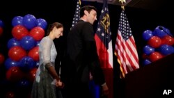 Democratic candidate for 6th congressional district Jon Ossoff, right, steps onstage with his fiancee Alisha Kramer to announce he conceded to Republican Karen Handel at his election night gathering in Atlanta, Georgia, June 20, 2017. 