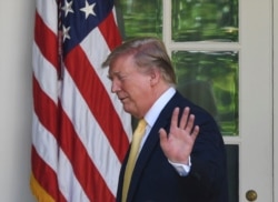 FILE - U.S. President Donald Trump waves after speaking in the Rose Garden of the White House in Washington, June 14, 2019.