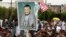 FILE - Supporters of the Shi'ite Houthi hold a poster of the group's leader Abdul-Malik al-Houthi during an anti-government rally in Sanaa, August 29, 2014.