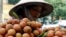A vendor transports lychees for sale on the street in Hanoi, June 14, 2007. 