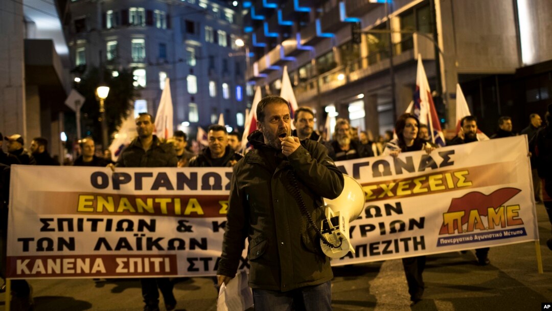 A protester shouts slogans during a demonstration against government plans to expand the number of auctions of foreclosed properties, in central Athens, Feb. 21, 2018. 