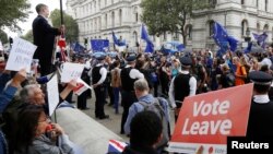 FILE - Brexit supporters form a counterdemonstration as pro-Europe activists protest during a "March for Europe" against the Brexit vote result earlier in the year, in London, Sept. 3, 2016. 