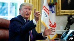 President Donald Trump speaks in the Oval Office of the White House in Washington, Friday, July 26, 2019. 