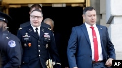 FILE - In this Nov. 19, 2019, photo, National Security Council aide Lt. Col. Alexander Vindman, left, walks with his twin brother, Army Lt. Col. Yevgeny Vindman, after testifying in President Donald Trump's impeachment hearing.