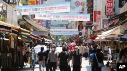 People walk on a shopping district in Seoul, South Korea, June 11, 2020.