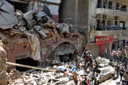 French and Lebanese firemen search in the rubble of a building after the Tuesday explosion at the seaport of Beirut, Lebanon, Aug. 6, 2020.