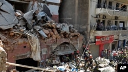 French and Lebanese firemen search in the rubble of a building after the Tuesday explosion at the seaport of Beirut, Lebanon, Aug. 6, 2020.