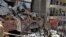 French and Lebanese firemen search in the rubble of a building after the Tuesday explosion at the seaport of Beirut, Lebanon, Aug. 6, 2020.