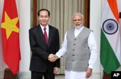 Indian Prime Minister Narendra Modi, right, shakes hands with Vietnamese President Tran Dai Quang, before their delegation level meeting in New Delhi, India, Saturday, March 3, 2018.