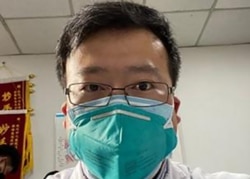 Chinese coronavirus whistleblower, Dr. Li Wenliang, whose death was confirmed on Feb, 7, 2020, is shown in his protective mask, at the Wuhan Central Hospital, China.