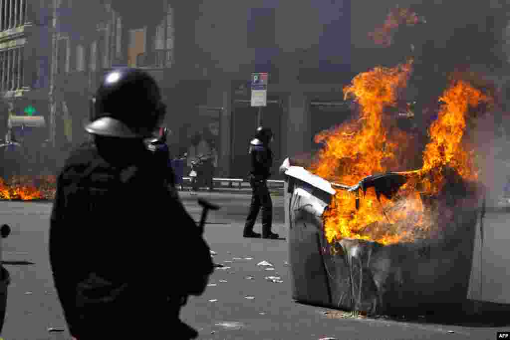 Trash containers set fire during clashes with demonstrators during the general strike in Barcelona, March 29, 2012. (AP)