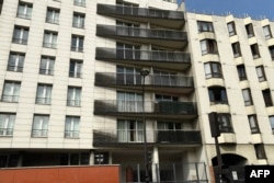 FILE - This picture taken May 28, 2018, shows the facade of a building in Paris scaled by Mamoudou Gassama from Mali to save a 4-year-old child dangling from a balcony.