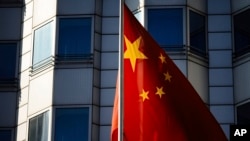 The Chinese national flag waves in front of the country's embassy in Berlin, April 23, 2024. A man who works for a German lawmaker in the European Parliament has been arrested on suspicion of spying for China, German prosecutors said. 