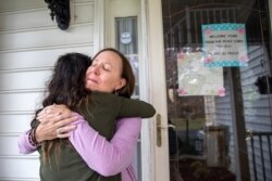 Holly Balcom, 54, hugs her daughter Kelsea Mensh, 22, as they reunite at their home in Dumfries, Va., April 1, 2020.