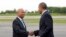 In this June 11, 2014, file photo, President Barack Obama is greeted by then-Massachusetts Gov. Deval Patrick, upon his arrival at Worcester Regional Airport in Worcester, Mass. 