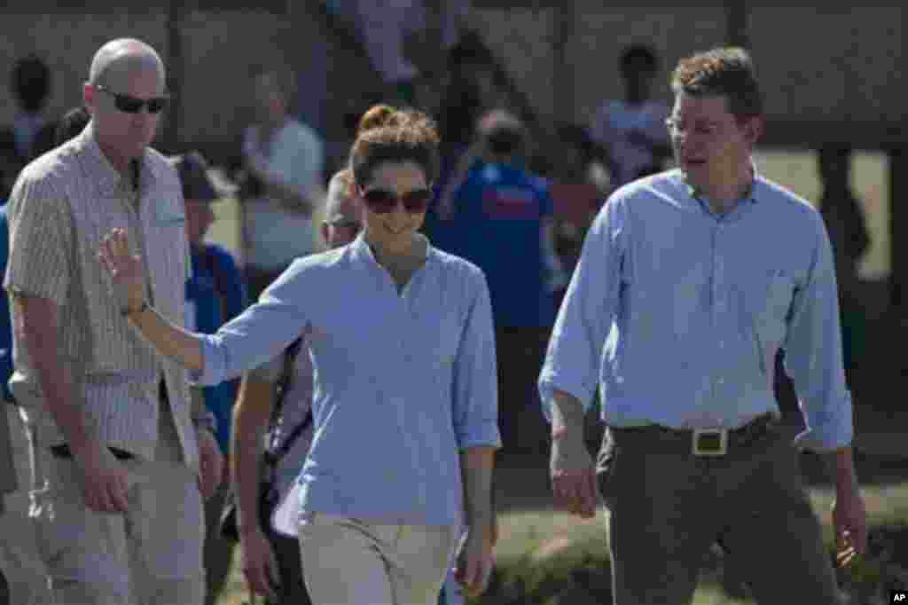 Denmark’s crown princess Mary, center, and Denmark’s minister for development cooperation Rasmus Helveg Petersen, right walk during a visit to a Buddhist resettlement village in Sittwe, Rakhine State, Myanmar, Sunday, Jan. 12, 2014. Crown princess Mary, a