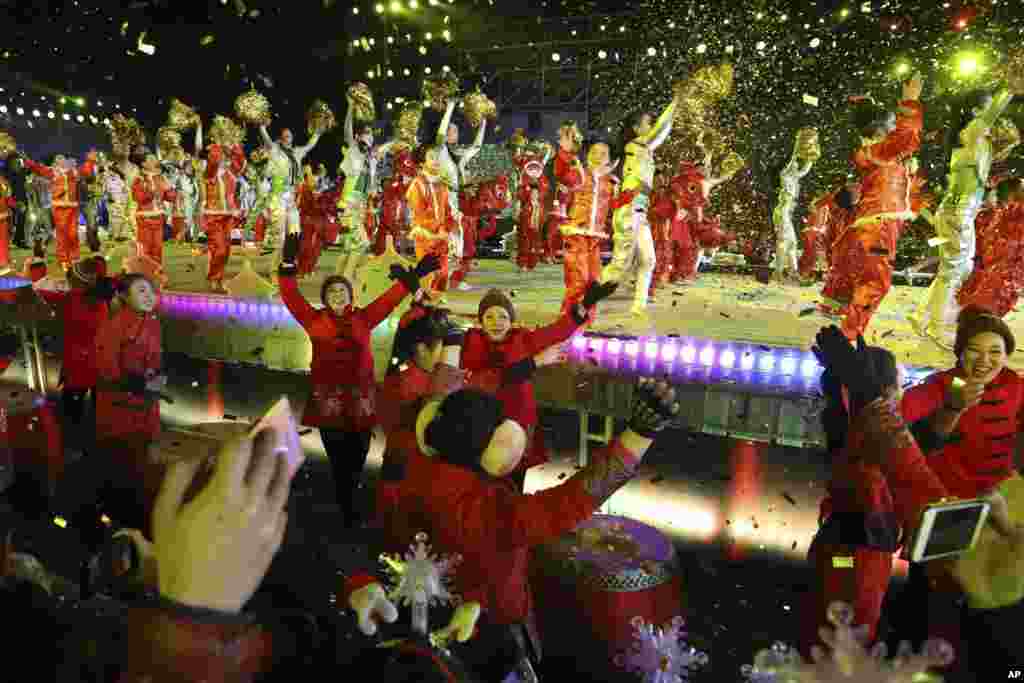 Participants of a count down to the New Year event marking the passage into 2018 in Beijing, China, Monday, Jan. 1, 2018. 