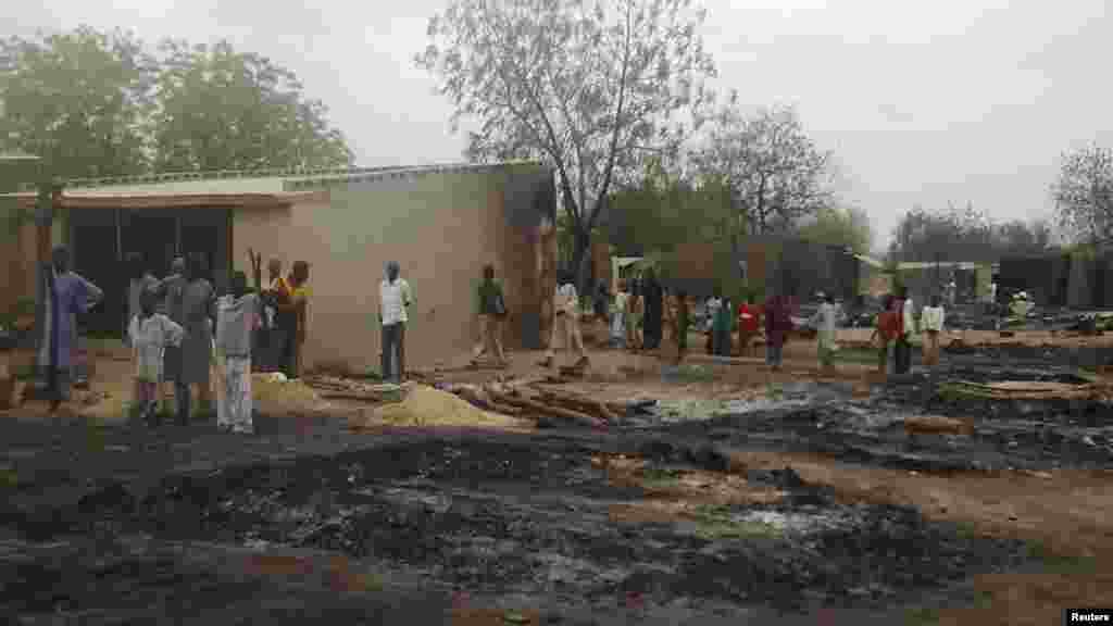Residents gather at the border town of Baga, after heaving fighting between security forces and Islamist militants, April 21, 2013.