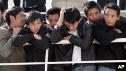 Chinese citizens wait aboard the 'Palermo Grimaldi' ferry at the harbor in Valletta, Malta, after being evacuated from Benghazi, Libya, Feb. 26, 2011.