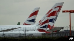 British Airways planes sit parked at Heathrow Airport in London, Sept. 9, 2019. British Airways says it has had to cancel almost all flights as a result of a pilots' 48-hour strike over pay. 