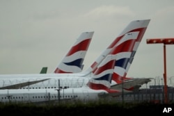 FILE - British Airways planes sit parked at Heathrow Airport in London, Sept. 9, 2019.