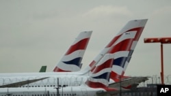 British Airways planes sit parked at Heathrow Airport in London, Sept. 9, 2019. British Airways says it has had to cancel almost all flights as a result of a pilots' 48-hour strike over pay. 