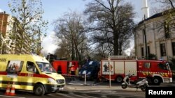 Belgian firefighters stand outside the Grand Mosque in Brussels, Belgium, Nov. 26, 2015, after a powder feared to be Anthrax was found.