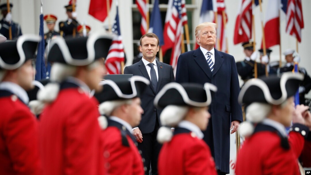 President Donald Trump and French President Emmanuel Macron stand during a State Arrival Ceremony on the South Lawn of the White House in Washington, April 24, 2018.