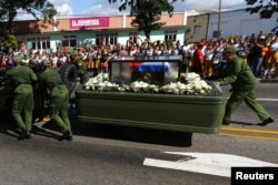 Soldiers push the vehicle and trailer carrying the ashes of the late Cuban leader Fidel Castro after suffering a mechanical issue in Santiago de Cuba, Cuba, Dec. 3, 2016.